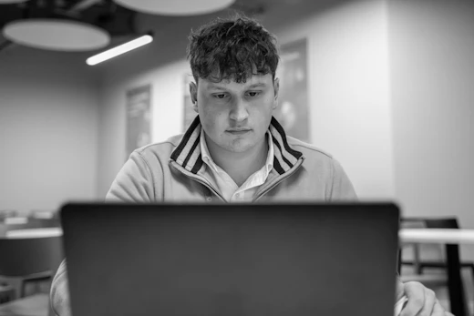 A student looks at a laptop screen