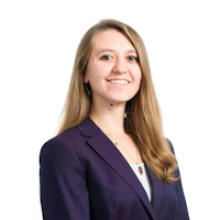 A portrait shot of a young woman in a blue jacket