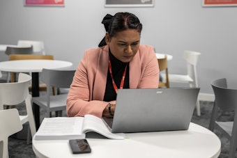 A woman works on a laptop