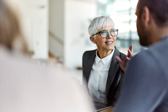 A woman speaking to a man