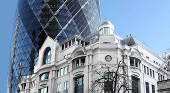 An outside shot of a building infront of The Gherkin in London