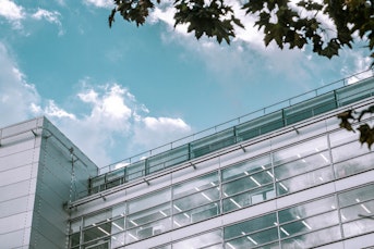 An image of a glass building and blue sky