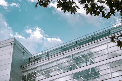 An image of a glass building and blue sky
