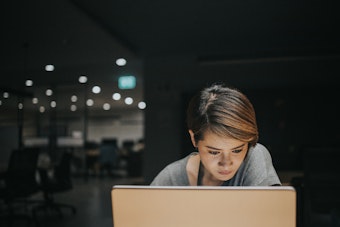 Woman looking at laptop