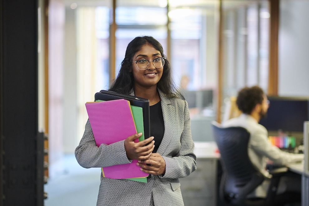 Woman walking holding files