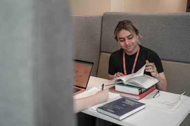 A male student reads a book in a study booth