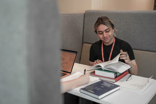 A male student reads a book in a study booth