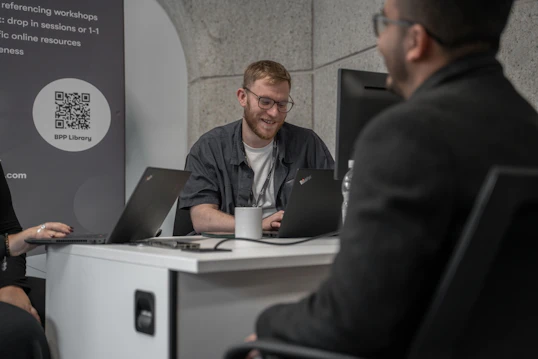 A male member of staff speaks to a student