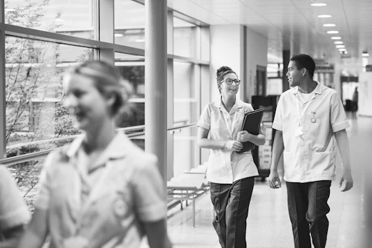 A male and female nurse are having a conversation