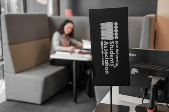 A BPP Students Association sign infront of a student