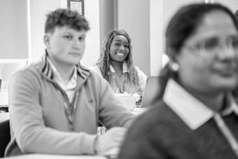 Male and female students sit in a classroom