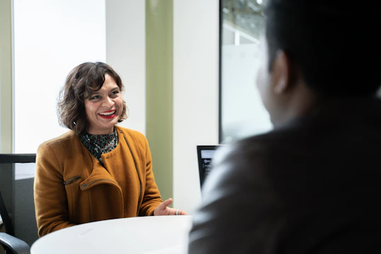 A female member of staff speaks to a student