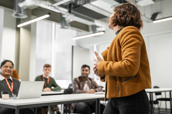A woman speaks to a class of students