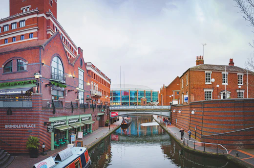 Shops, brick buildings and boats line the canal at Brindleyplace in Birmingham