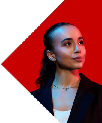 A smartly-dressed woman looks into the distance