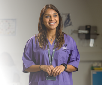Nurse in a health setting smiling