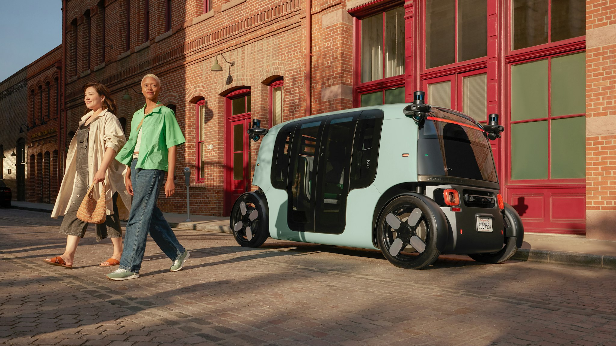 Passengers walking away from a Zoox vehicle