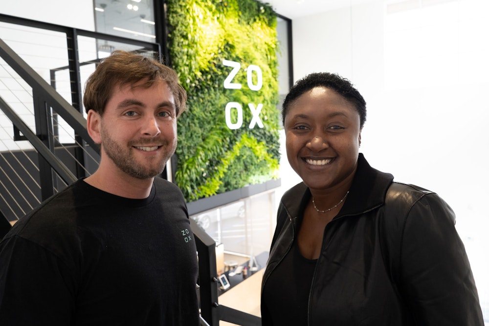 Jesse Levinson and Aicha Evans in front of a Zoox sign