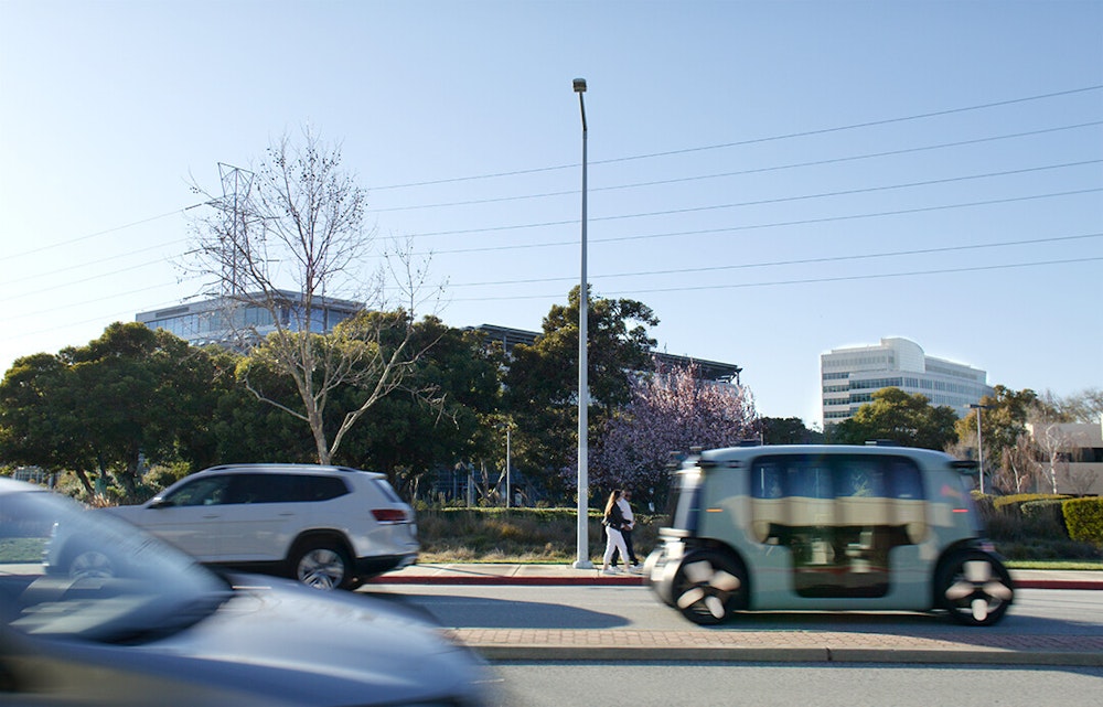 A blurred image of a Zoox vehicle driving by