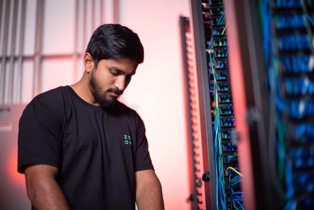 Zoox employee working in a server room
