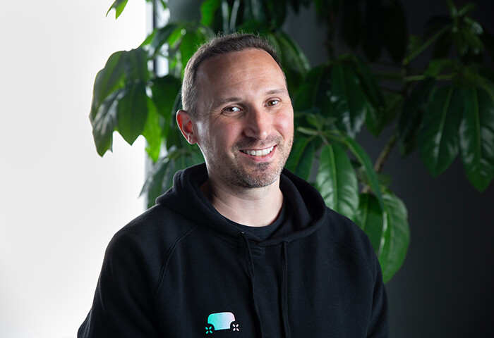 Zoox software simulation employee David in front of a plant