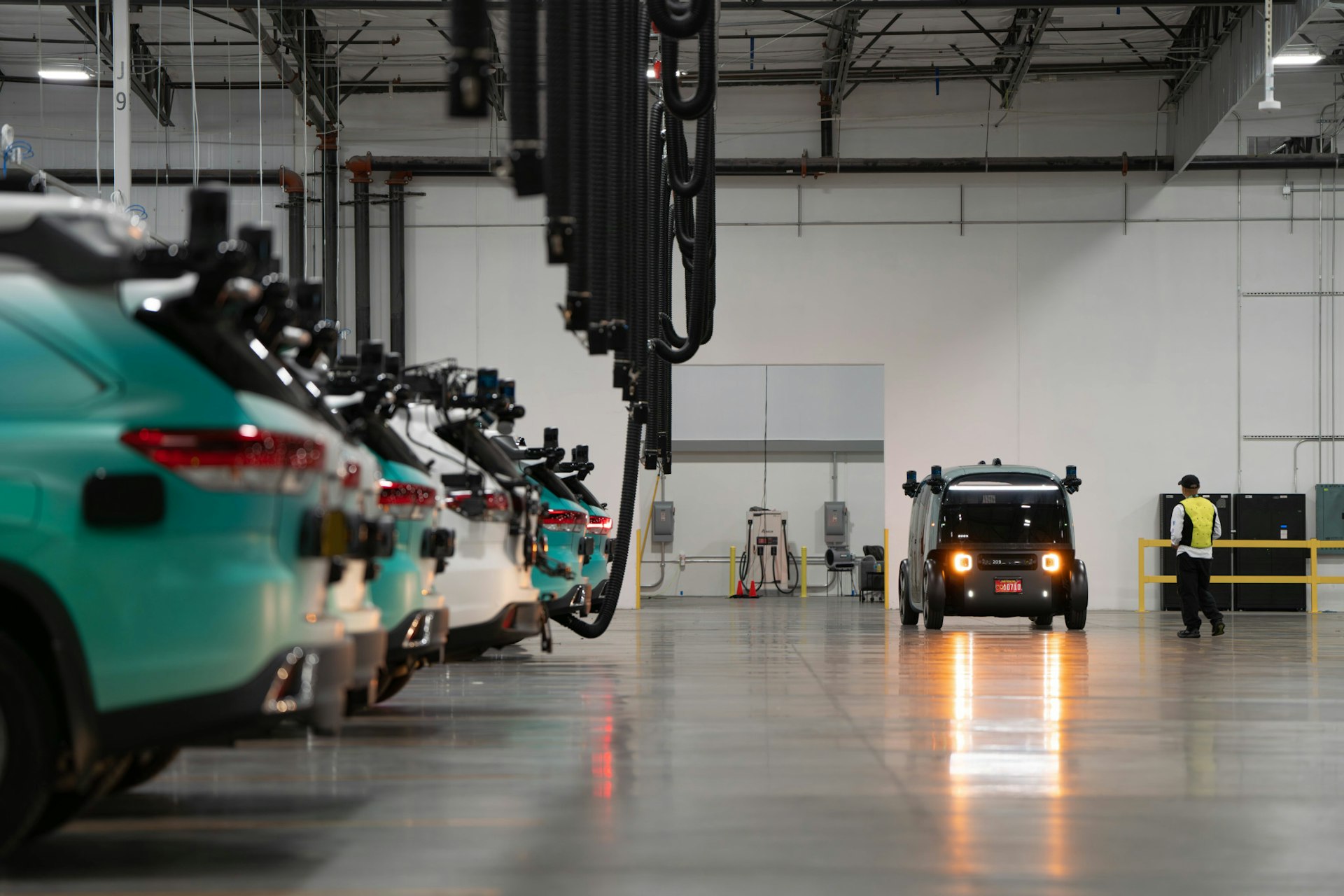 zoox robotaxi and test vehicles in las vegas warehouse