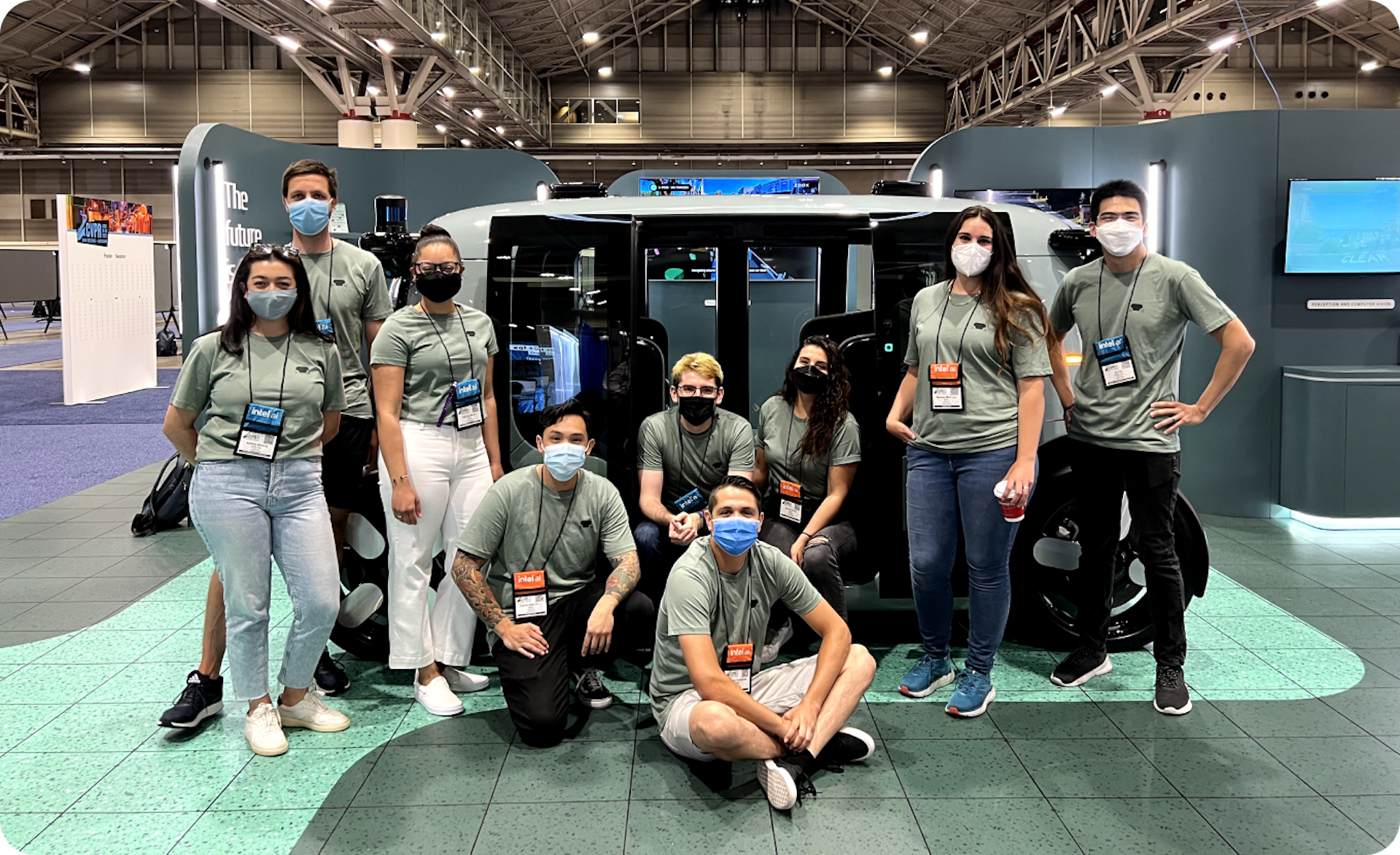 zoox team posing in front of robotaxi at CVPR