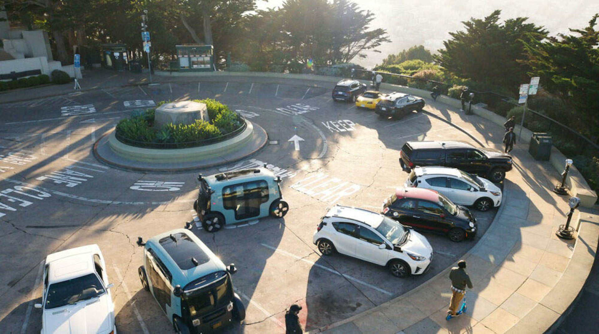 zoox robotaxi driving in a parking lot with cars in san francisco