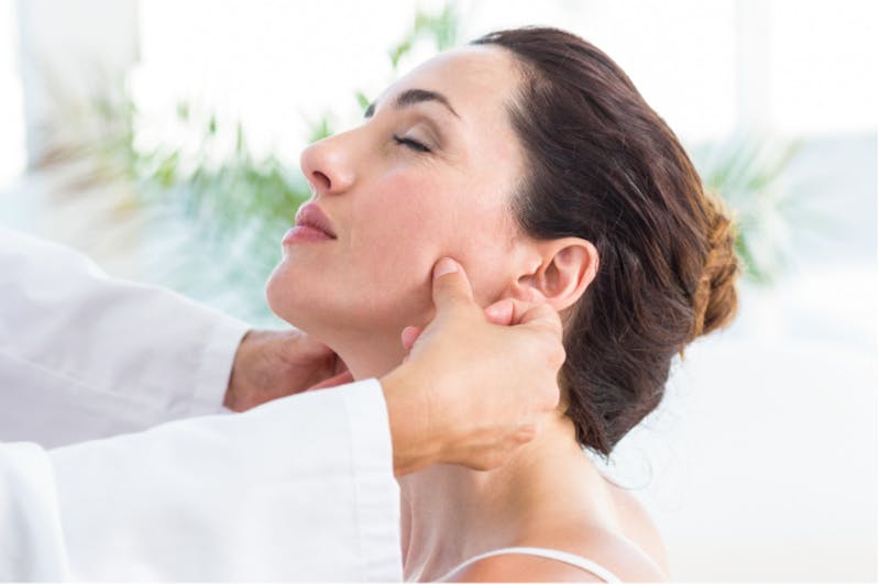 Woman having her jaw examined by a plastic surgeon