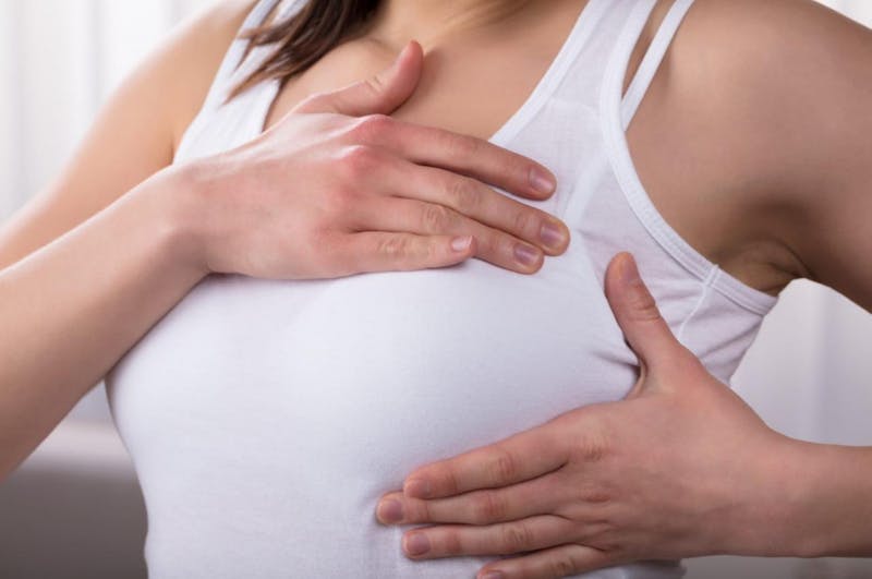 Woman examining her breast
