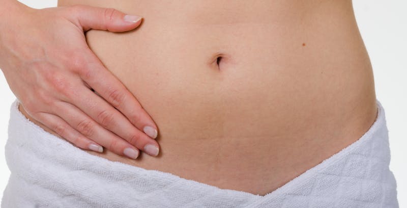Woman touching her abdominal area