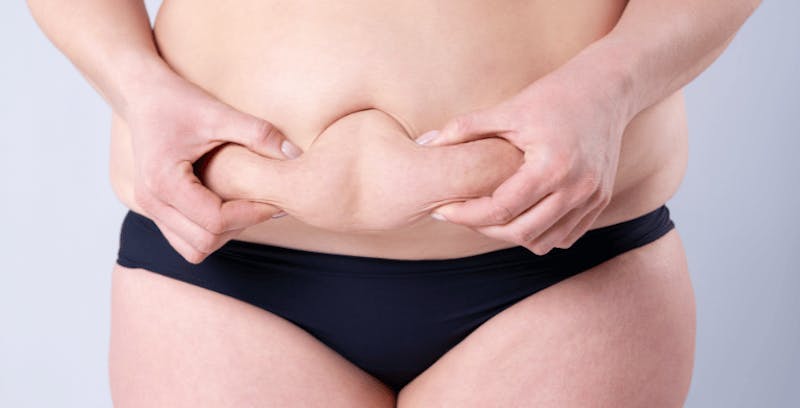 Woman grabbing her lower abdomen