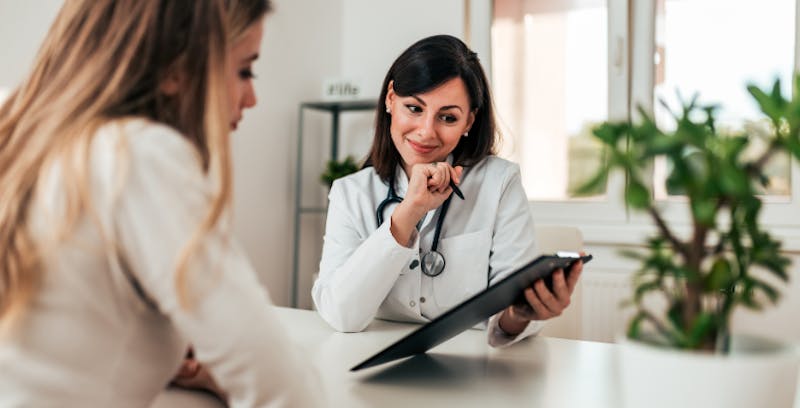 Staff and patient looking at a patient chart