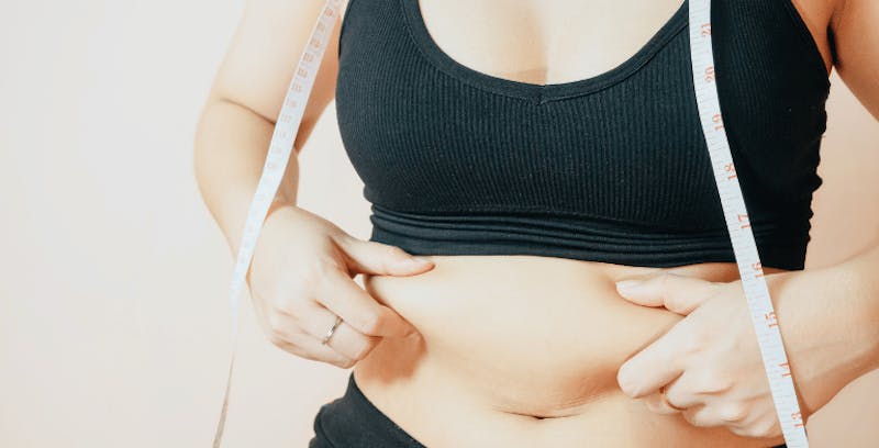 Woman grabbing her stomach area