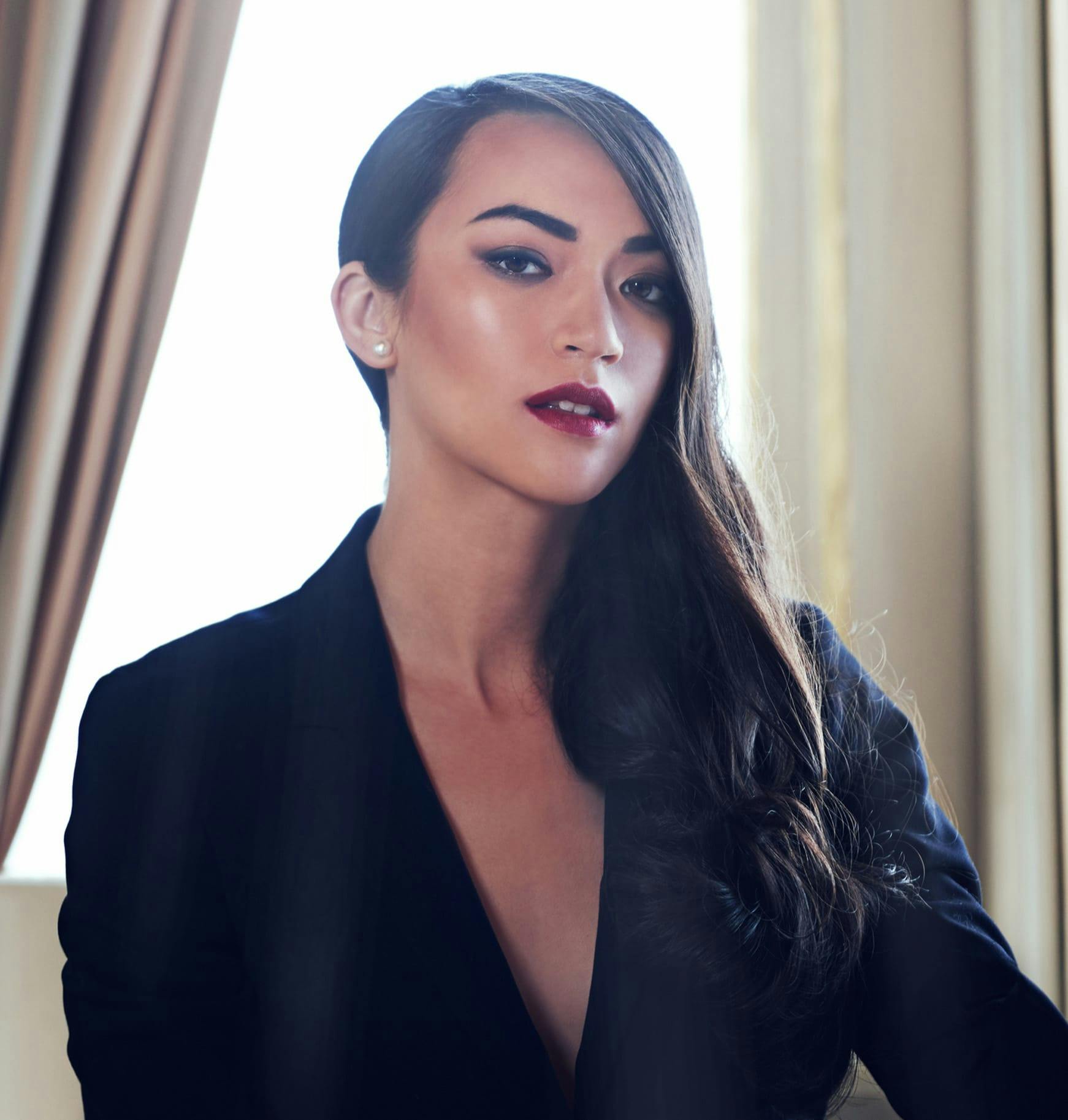 woman in a black suit posing for a picture