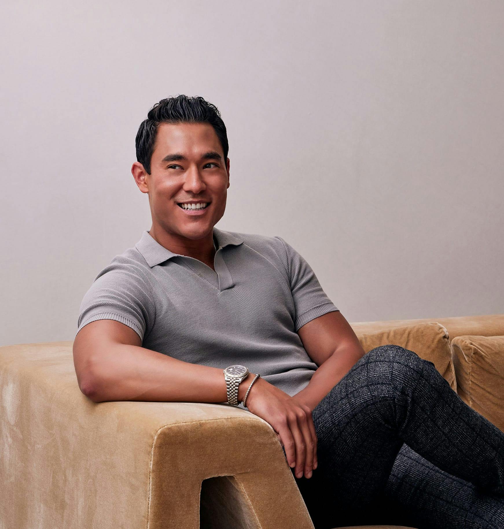 Dr. Walter J. Joseph sitting on a couch smiling and looking at the camera