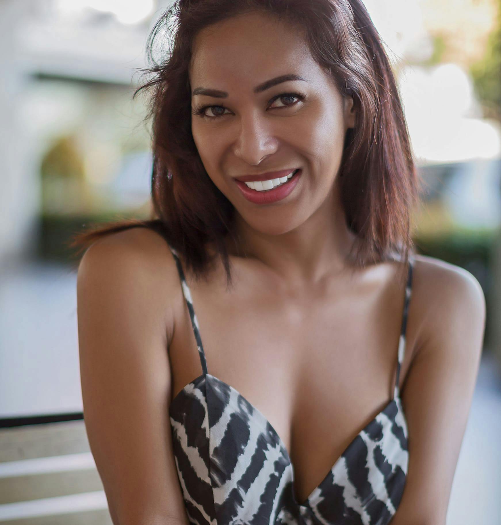 woman in a black and white dress posing for a picture