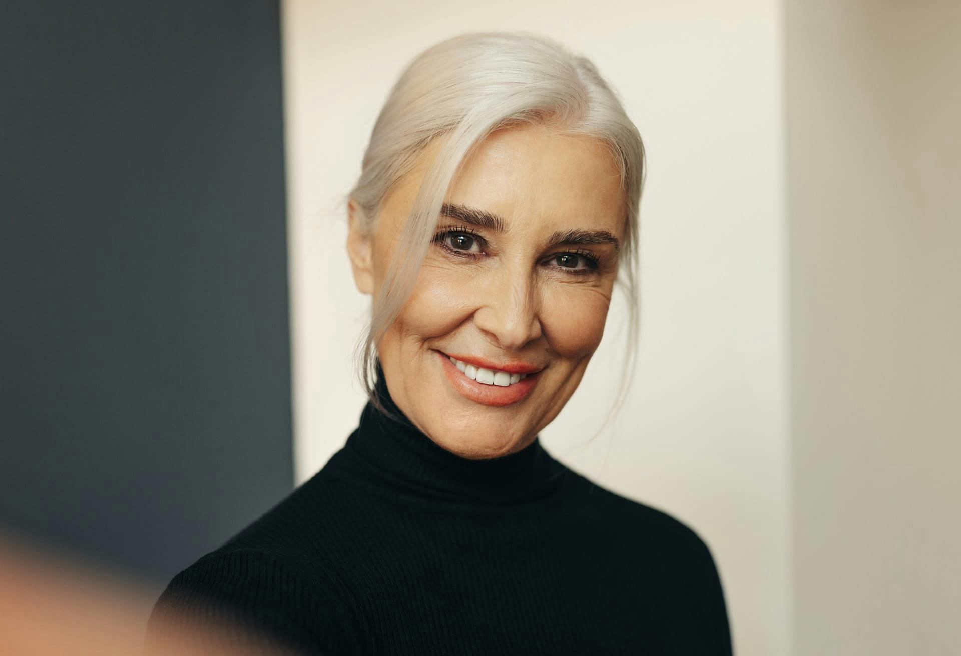 Woman with grey hair pulled back in a ponytail