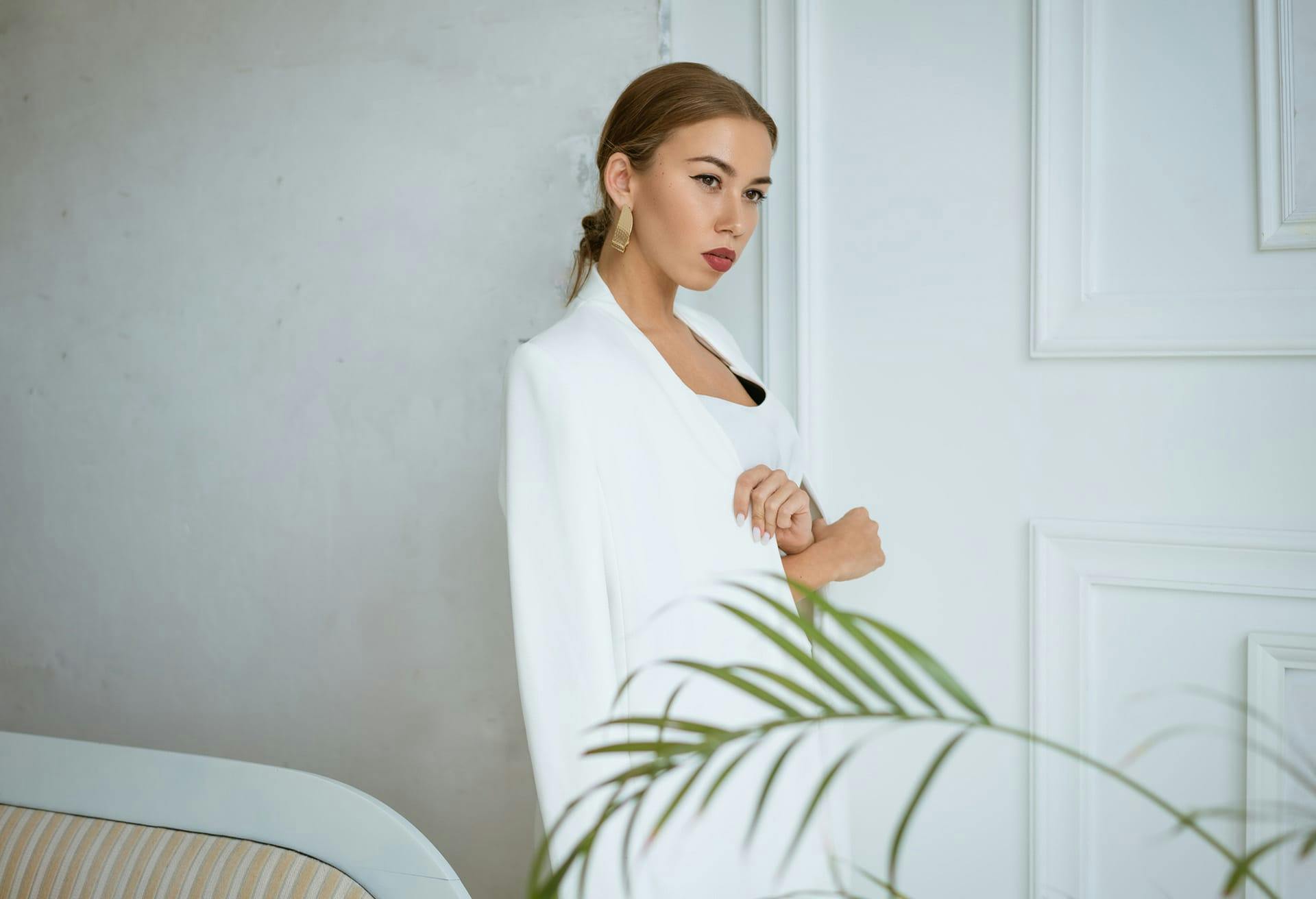 Glamorous woman in a white long coat