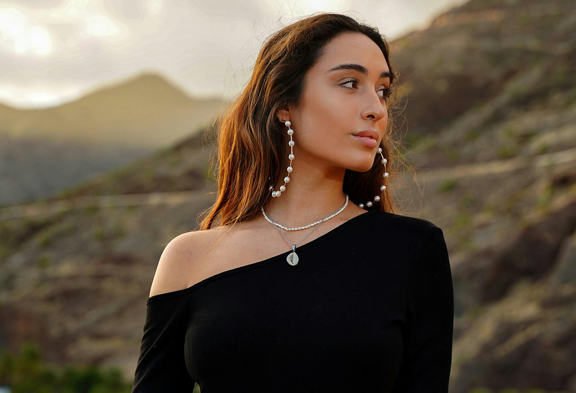 Woman wearing big pearl hoop earrings