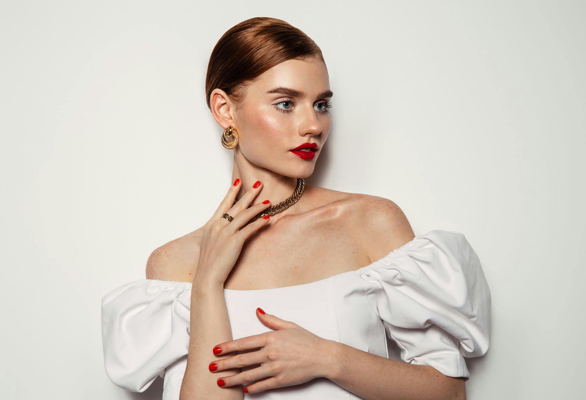 Woman with red hair wearing a white top