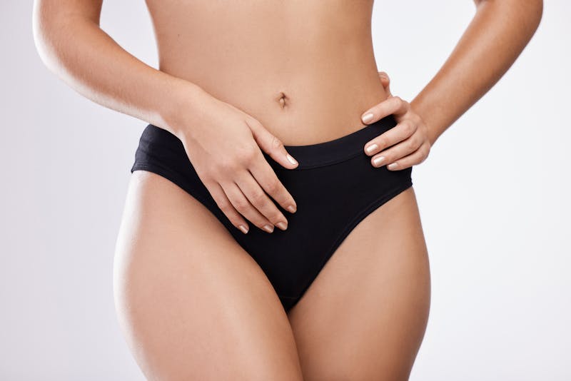close up of womans stomach and black bottoms