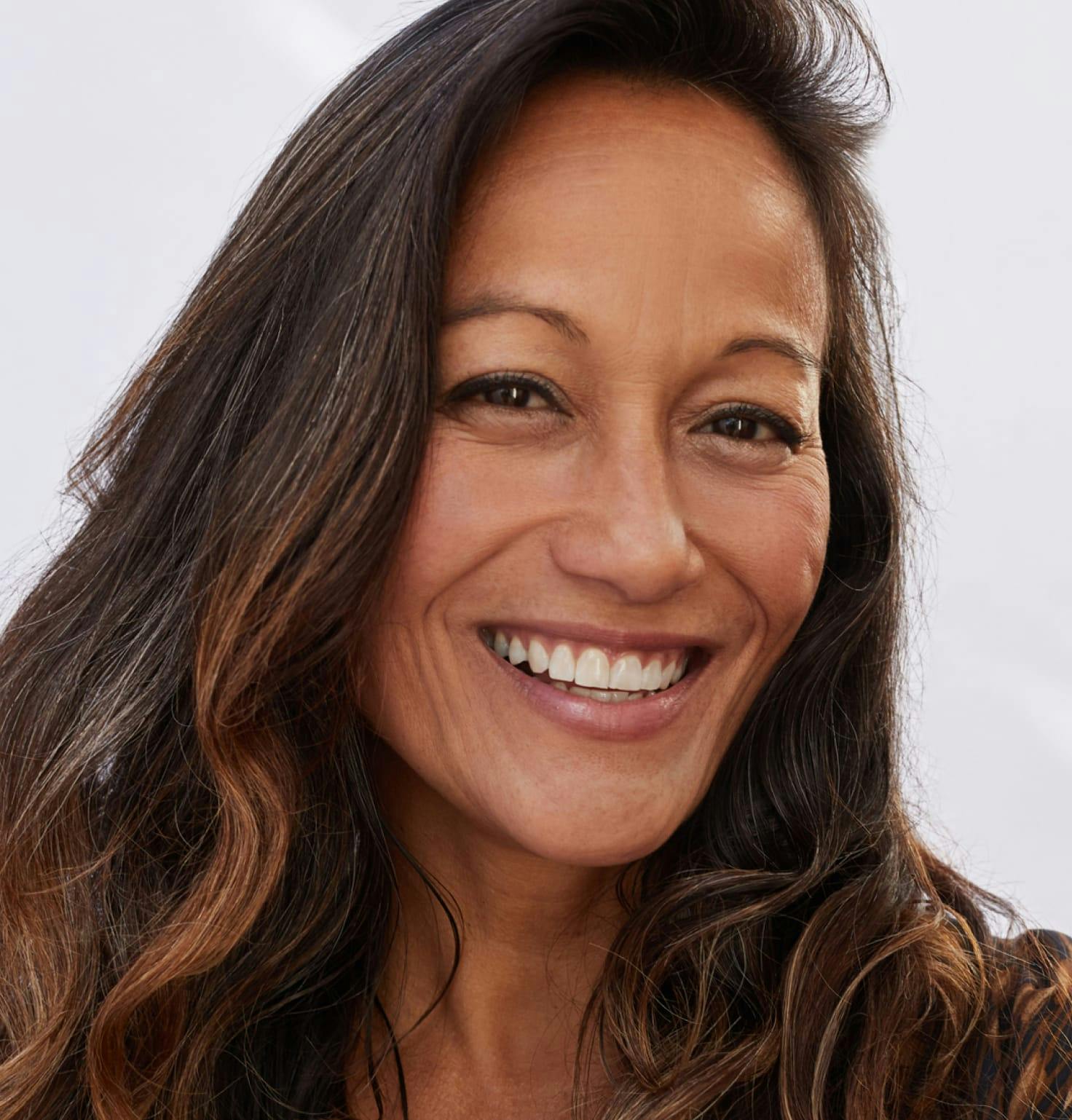 Woman with long dark hair smiling