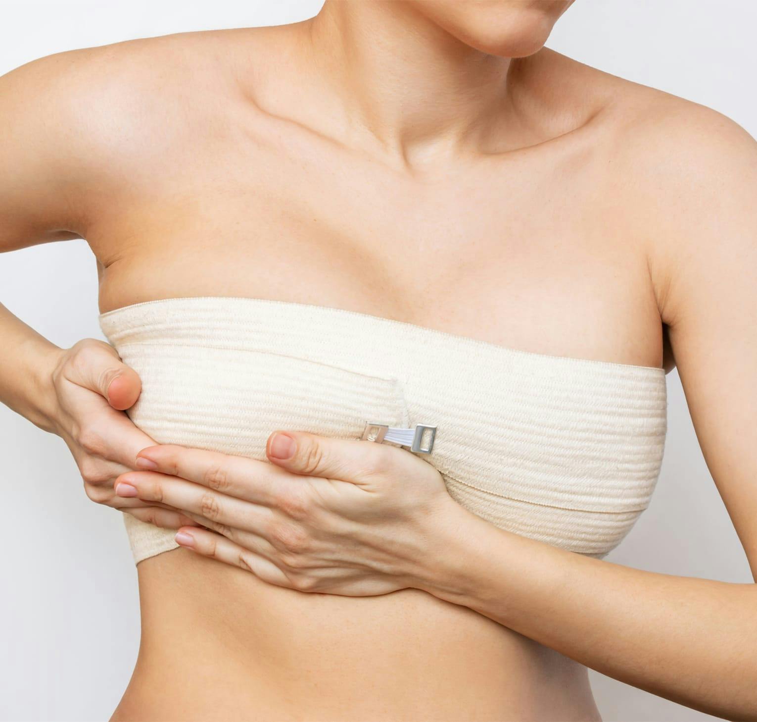 woman holding her breast