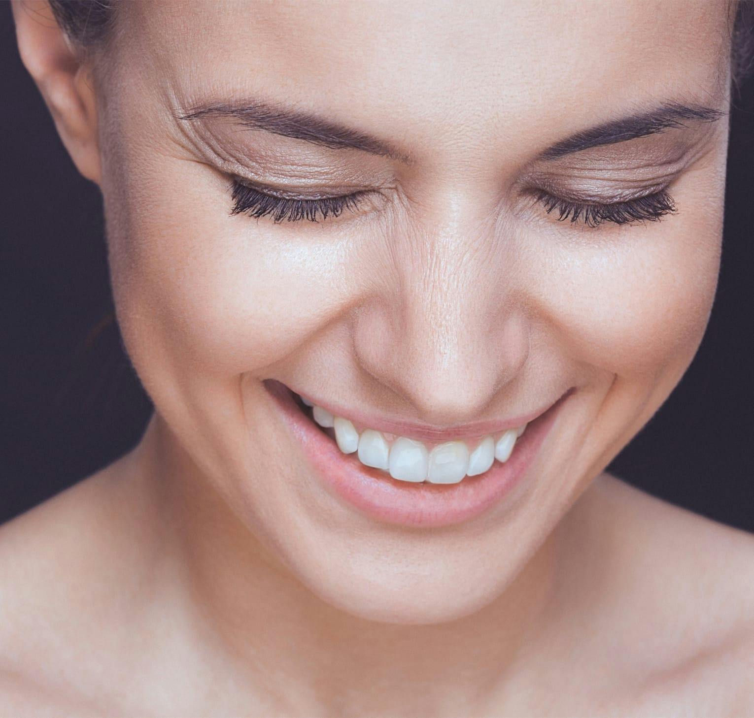woman smiling looking down