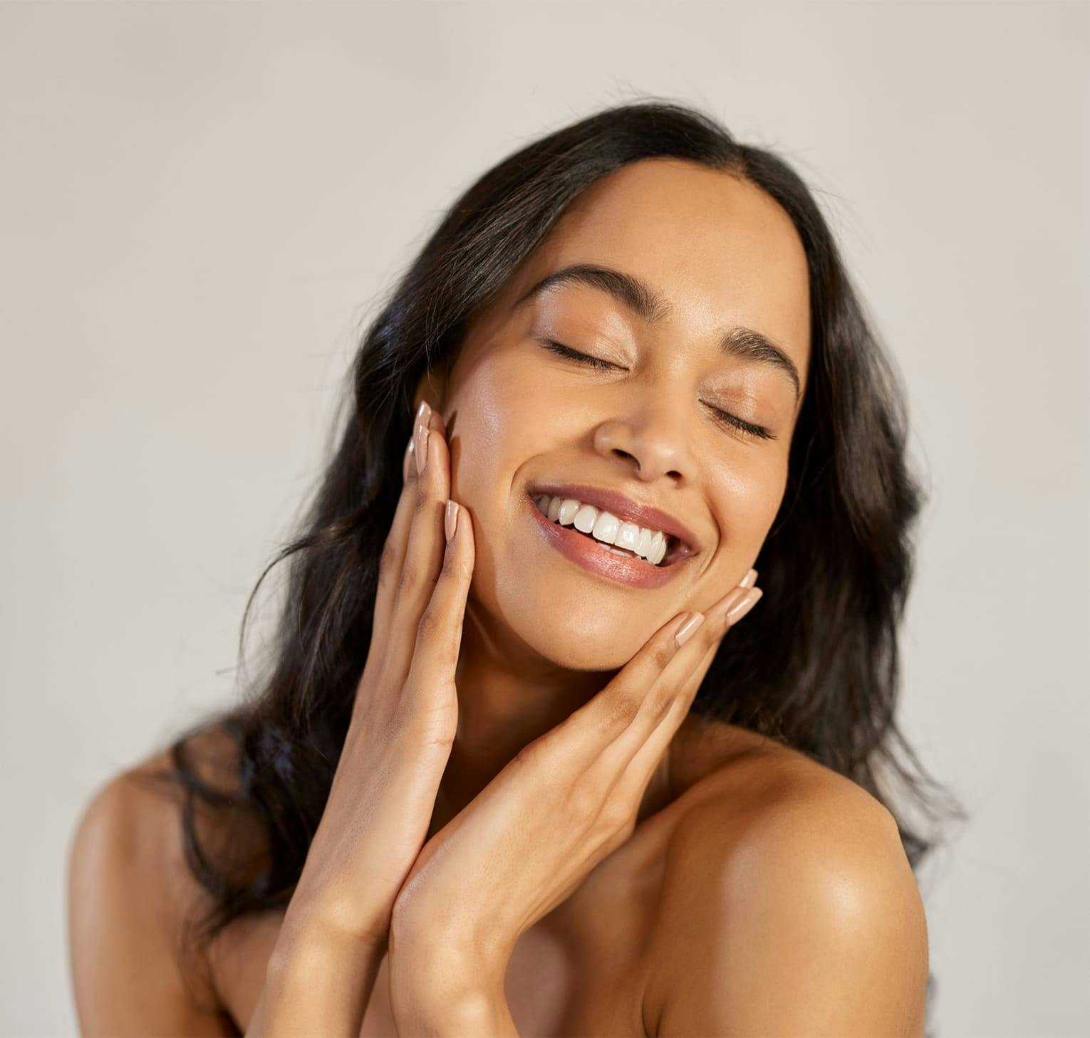 smiling woman cupping her face in her hands