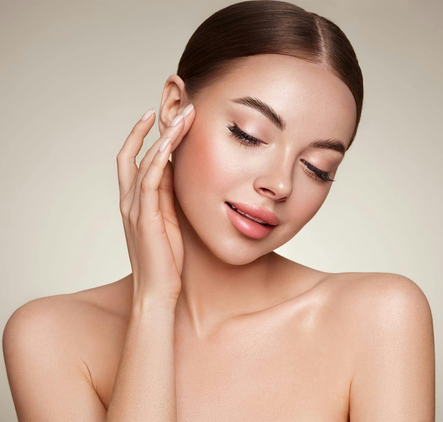 woman touching face with her hand