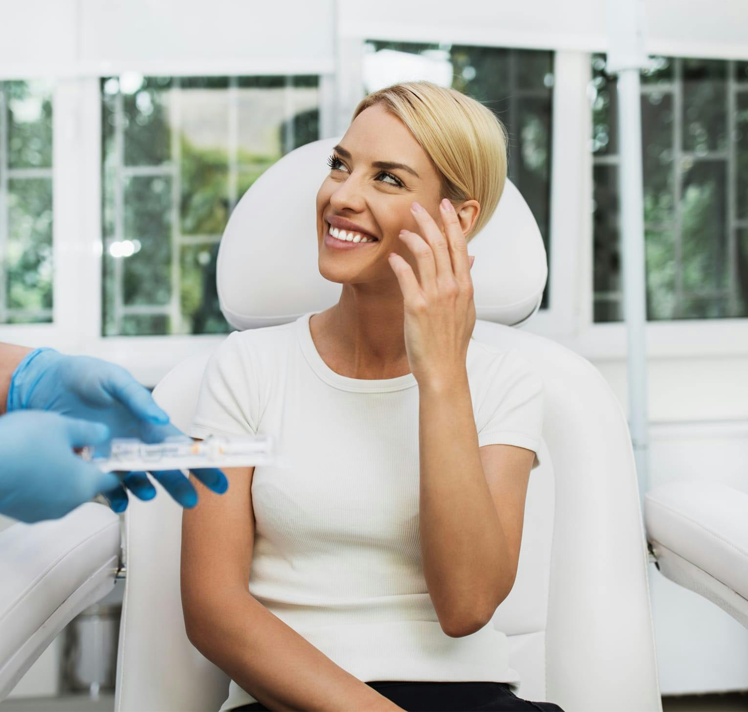 smiling woman holding hand up to her face