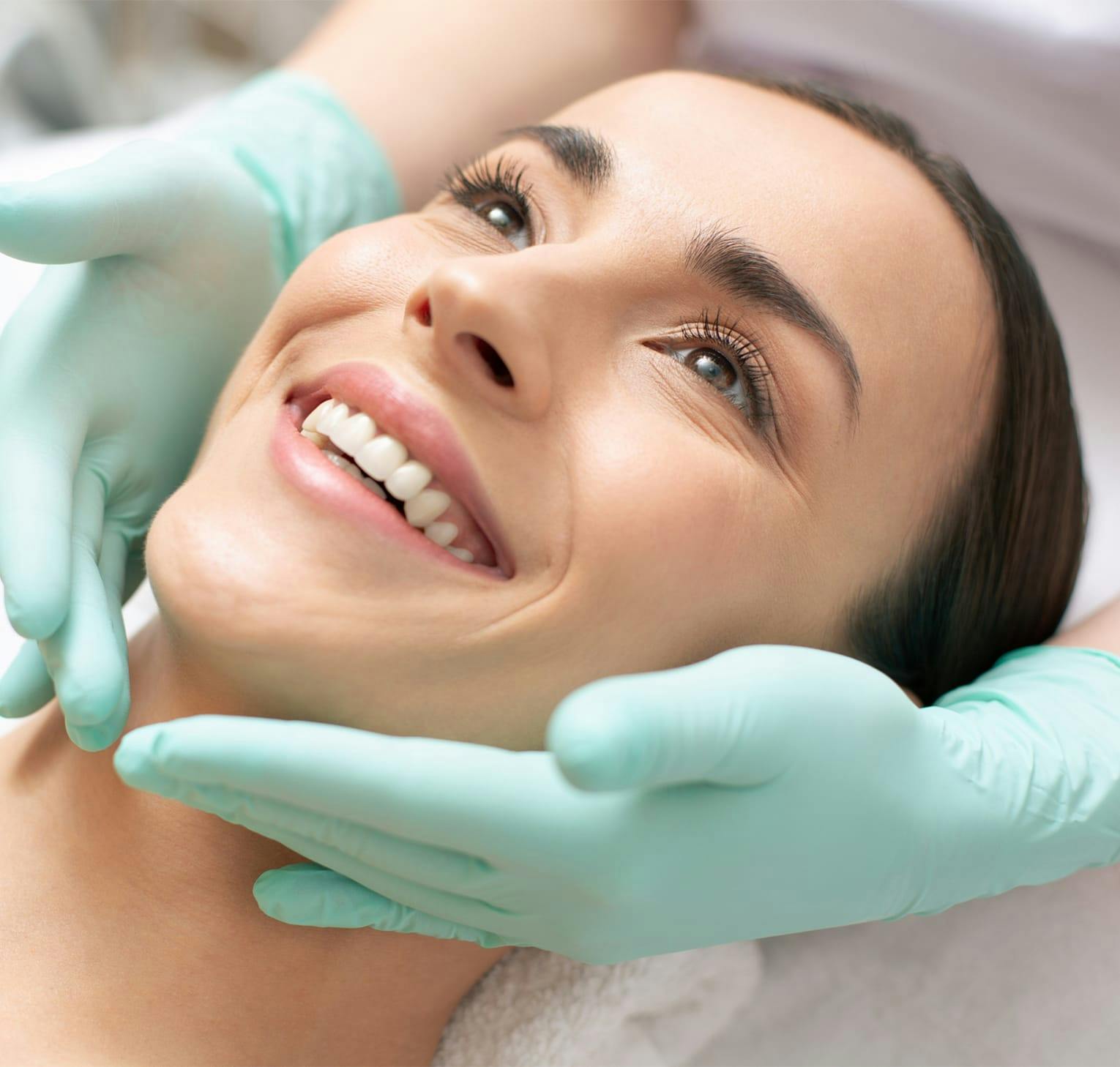 gloved hands around woman's face