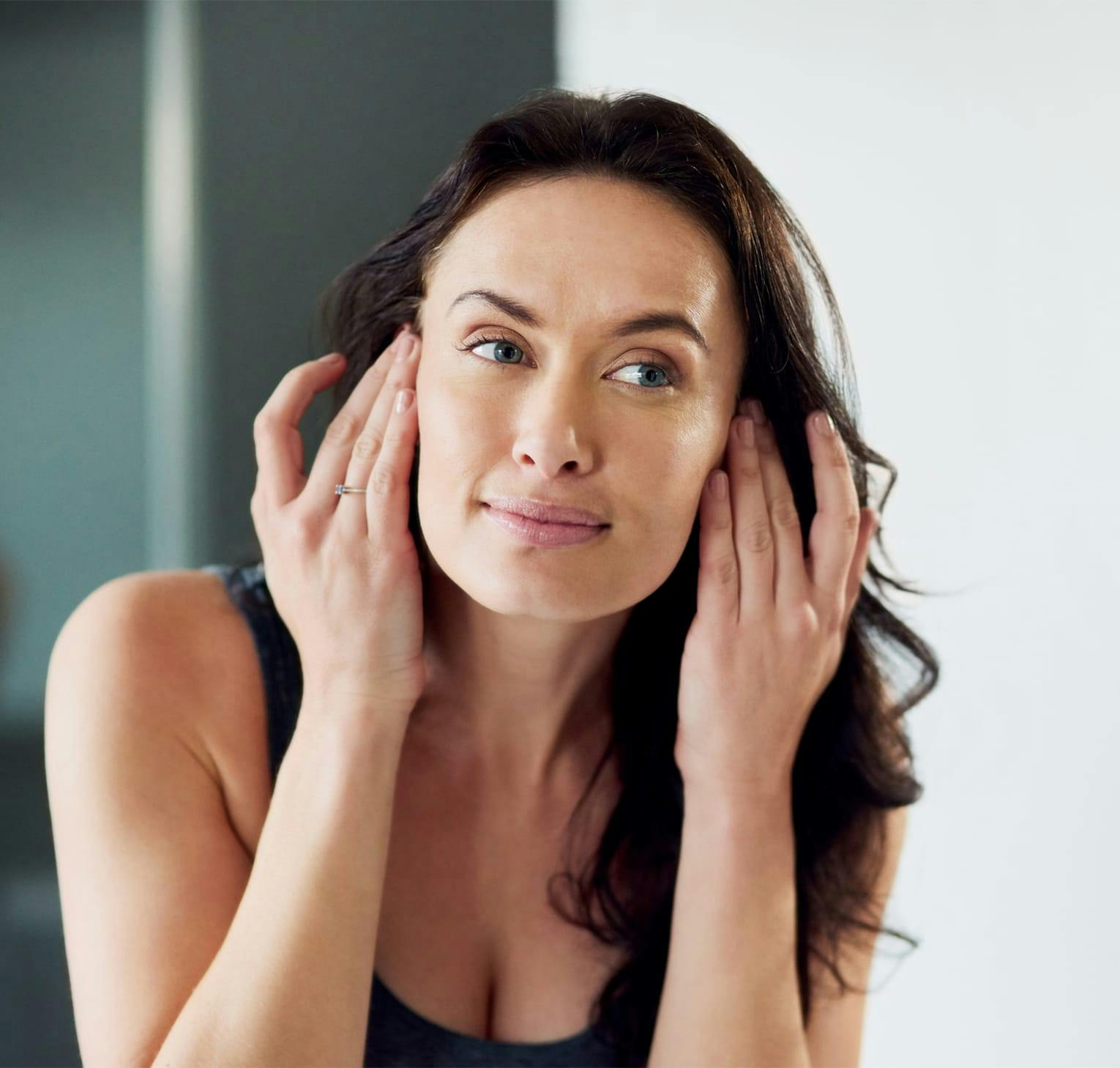 woman with hands by her face